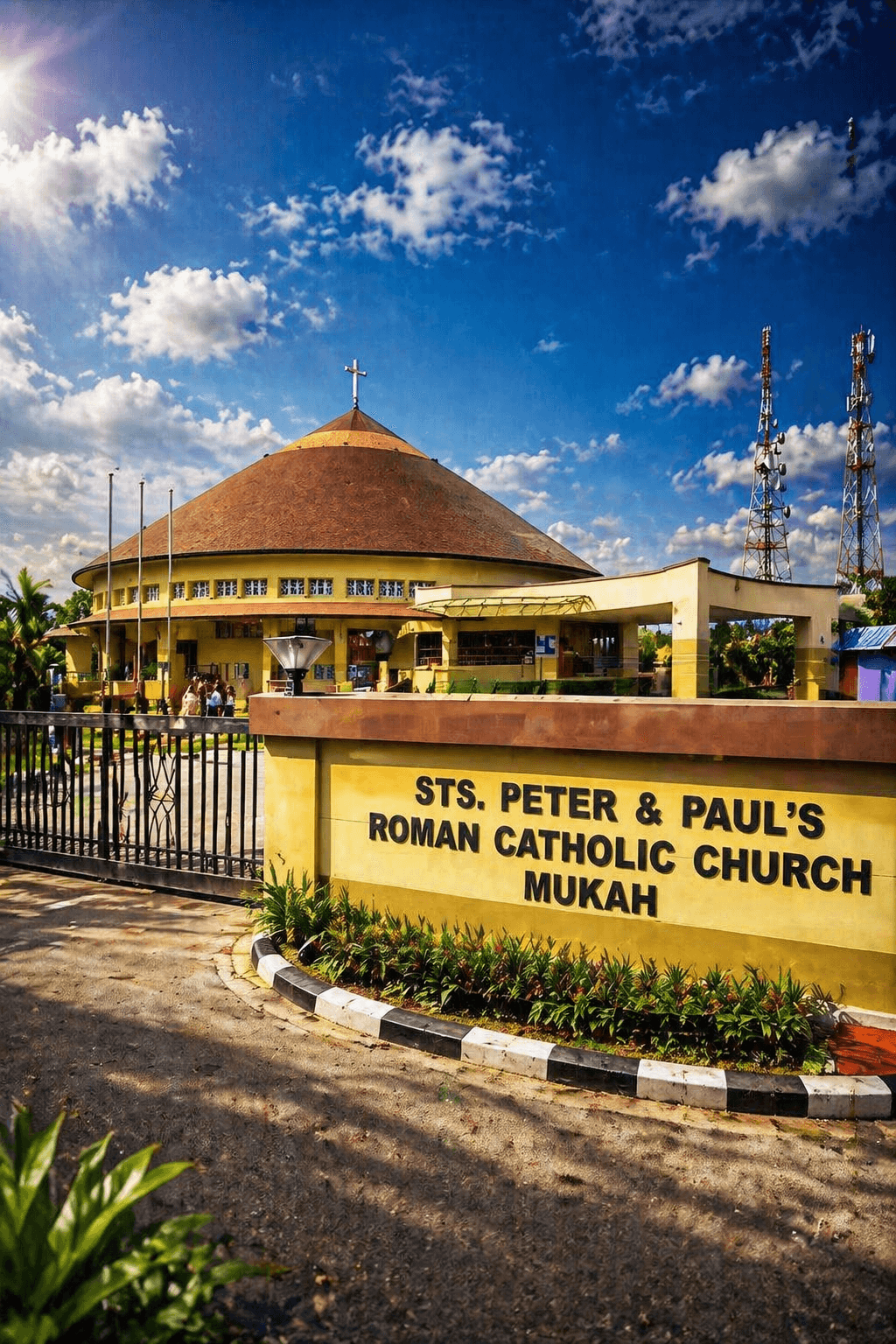 Sts. Peter and Paul's Roman Catholic Church in Mukah with yellow walls and conical roof.